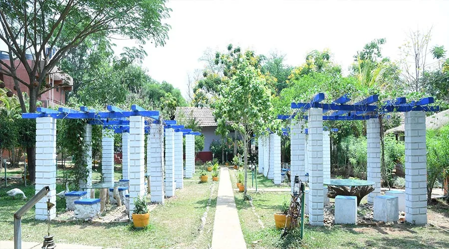 Blue-beam garden pergolas and outdoor seating at Century Resort Dandeli