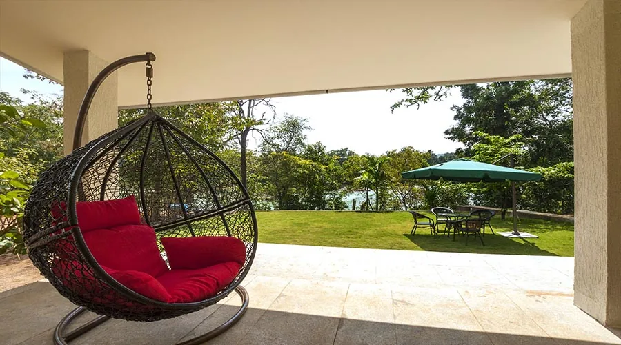 Porch and forest views at Whistling Woods Tree House Dandeli
