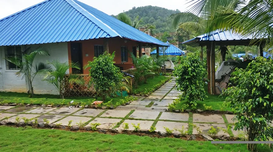 Garden and cottages at Jungle Bell River Resort Dandeli