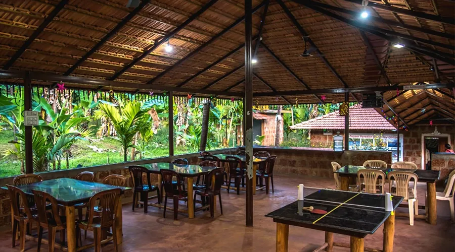 Bicycle stand under thatch shelter at Pepper Paradise Homestay Dandeli