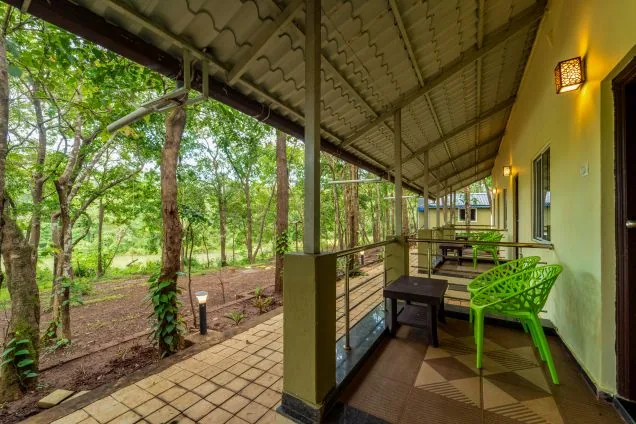 Cottage verandah looking into the forest at Rain Forest Dandeli