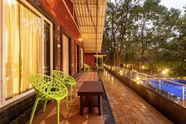Evening lights on the pool verandah at Rain Forest Dandeli