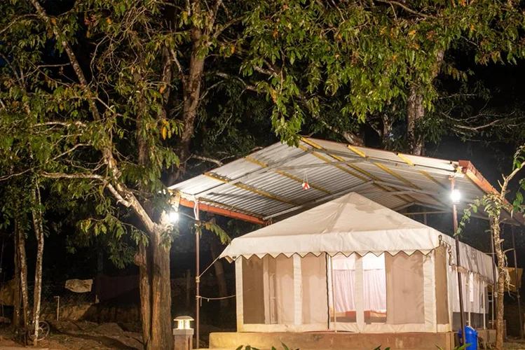 Canvas luxury tent under a metal roof at Tusker Trails Resort