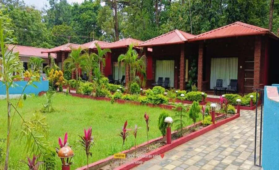 Row of red-roof cottages with lawn at Wild Wings Dandeli