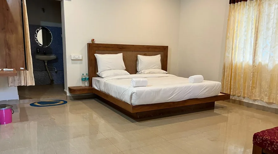 Cottage bedroom and attached bathroom at Woodpecker Homestay Dandeli