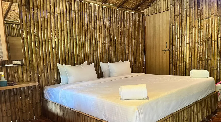 Bamboo cottage bedroom interior at Woodpecker Homestay Dandeli
